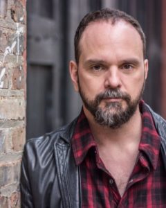 Headshot of actor Grant James Varjas